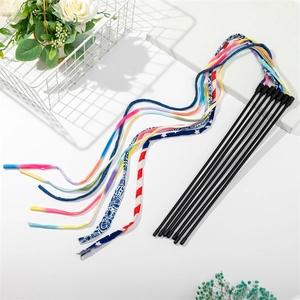 Macro detail of cat teaser wand set with colorful tassels and black flexible rods