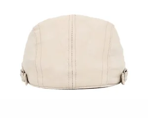 Detail view of adjustable metal side buckles on a beige textured ivy cap for men and women