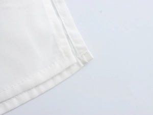 Macro shot of white fabric texture with high-quality double stitching on the seam