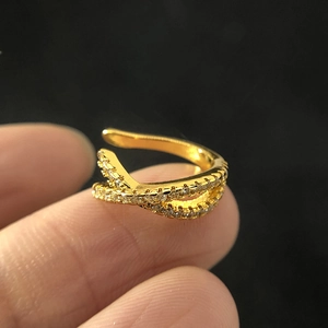 Close-up of gold double-layer crisscross ear cuff with micro-pave cubic zirconia