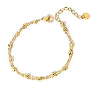 Detail of double-layer gold bead anklet with lobster clasp and extension chain