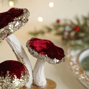 Burgundy velvet mushroom ornament with gold glitter accents for Christmas tabletop decor
