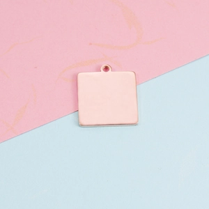 Close-up of rose gold geometric square pendant with hanging loop for DIY jewelry