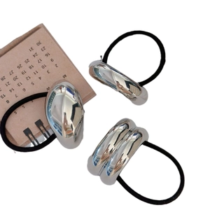 Minimalist silver U-shaped hair ties set with polished metal on black elastic bands