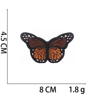 Detail view of a 8x4.5cm orange and black butterfly embroidery patch with dimensions