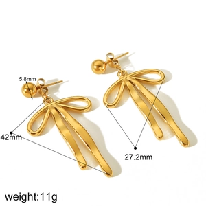 Polished golden ribbon bow earrings made of titanium steel shown from a 45-degree angle