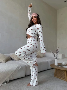 Detail of red cherry print pajamas with flared sleeves and red lettuce edge stitching