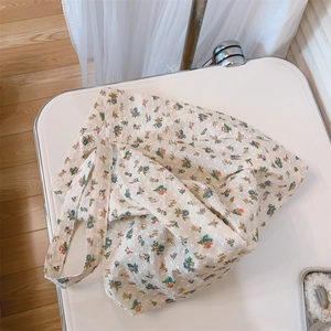 Detail of floral cotton tote bag featuring swiss dot texture and orange blue patterns