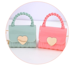 Detail of mini heart jelly handbags in mint green and pink with gold hardware