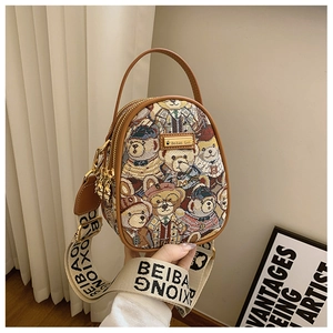 Detail of bear jacquard pattern mini backpack with brown leather trim and gold brand plaque