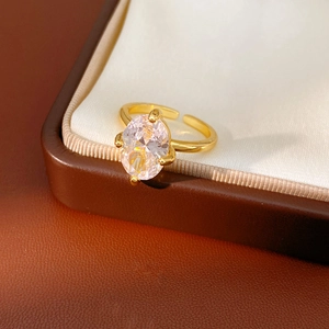 Macro detail of 18k gold plated ring with oval zircon in a four-prong setting