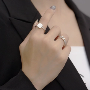Close-up of S925 silver irregular geometric rings with disk and beads on model hand