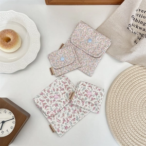 Detailed view of floral cotton pouches in two sizes with snap closure for small items