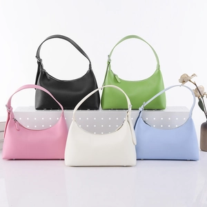 French style half-moon underarm bags in five colors on a white display stand
