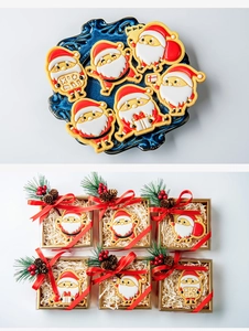 Detail view of 6-piece Santa Claus cookie set with gift boxes and pine cone decor