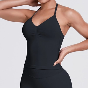 Detail of ruched front and slim halter straps on a black seamless compression yoga top