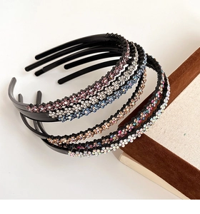 Detail shot of non-slip headbands with colorful rhinestones on a white surface