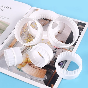 Detailed view of 6-piece white round wavy-edge cookie cutters for DIY baking and pastry