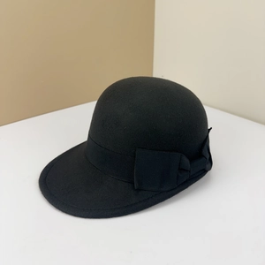 Vintage black wool equestrian cap for women featuring a minimalist side ribbon bow design