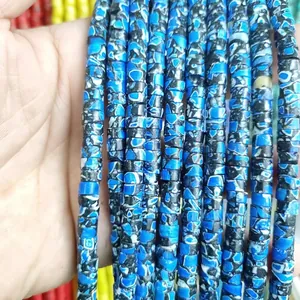 Macro detail of blue and white marble pattern cylindrical natural stone beads for DIY jewelry