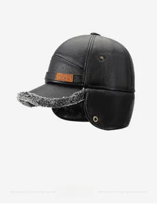 Detail of men's winter leather cap featuring thick gray faux fur lining and earflaps