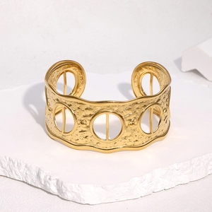 Adjustable 18k gold plated stainless steel cuff bracelet with hammered texture and cutouts