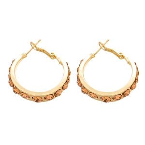 Elegant gold-plated geometric hoop earrings with amber rhinestones on a white background