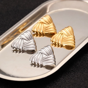 Detailed view of textured liquid lava triangle earrings in gold and silver finish
