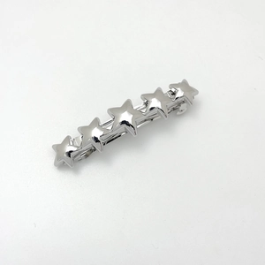 Detail view of five silver-finish metal stars in a row on a minimalist hair clip