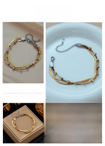 Detailed close-up of triple-layered titanium steel chain bracelet in tri-color metallic finish