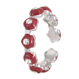 Close-up of vintage silver floral ring with dark red enamel and crystal accents