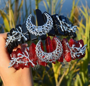 Close-up of handmade crystal cat ear crowns with moon and branch metal accents