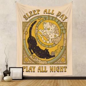 Detail of Boho tapestry featuring cats and sun moon graphics in a cozy room setting