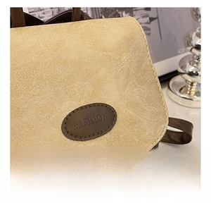 Macro shot of beige lychee grain leather texture and vintage FASHION embossed leather tag