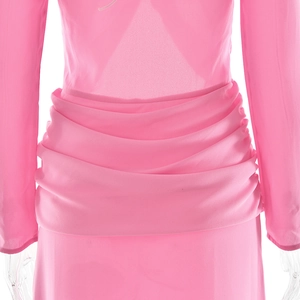 Close-up of pink ruched waist detail and lightweight fabric on summer mini dress