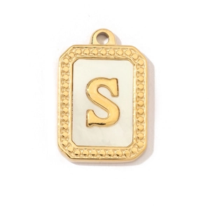 Detailed view of rectangular gold shell pendant with 3D letter S on white background