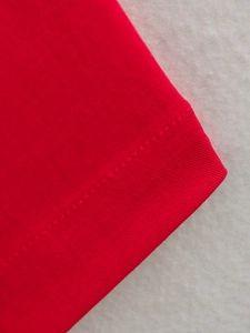 Gros plan du tissu sergé rouge montrant les coutures détaillées et la texture