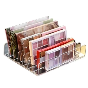 Clear acrylic eyeshadow palette organizer with multiple tiers on a clean white background