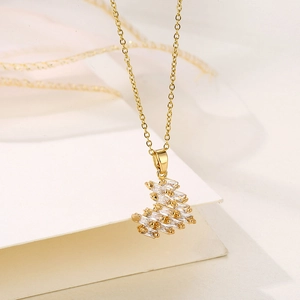 Golden heart necklace with zircon pendant on soft cream paper and silk ribbon
