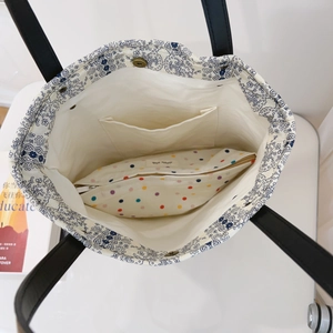 Detail of floral lining cotton tote bag with magnetic clasp and polka dot pouch