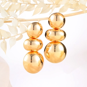 Statement gold metallic stacked spherical earrings with minimalist geometric art style