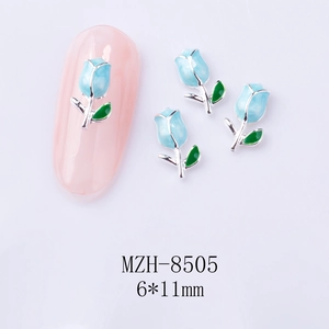 Macro shot of 6x11mm blue tulip nail art alloy charm with green leaves on white base