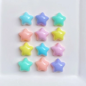 Close-up of twelve colorful macaron-style resin star charms for DIY crafts and accessories