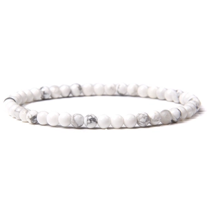 Detail of 4mm white howlite beaded bracelet with natural grey marble veining pattern