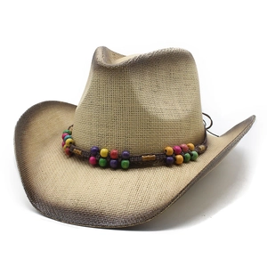 Detail of western straw hat featuring colorful wooden beads and distressed edges