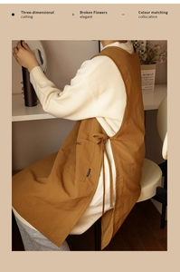 Detail view of brown canvas apron with side ties, large front pocket and premium stitching