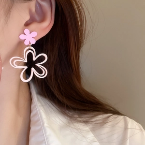 Close-up of pink layered flower earrings on a model for a sweet Korean style look
