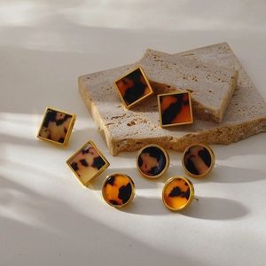 Retro geometric leopard print stainless steel earrings on a beige stone base