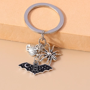 Detail of Halloween keychain with silver pumpkin, spider, and black bat charms
