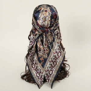 Navy blue silk square scarf with paisley and floral prints styled as a headwrap